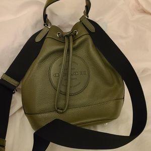 Coach drawstring backpack style purse, olive green in color with black straps